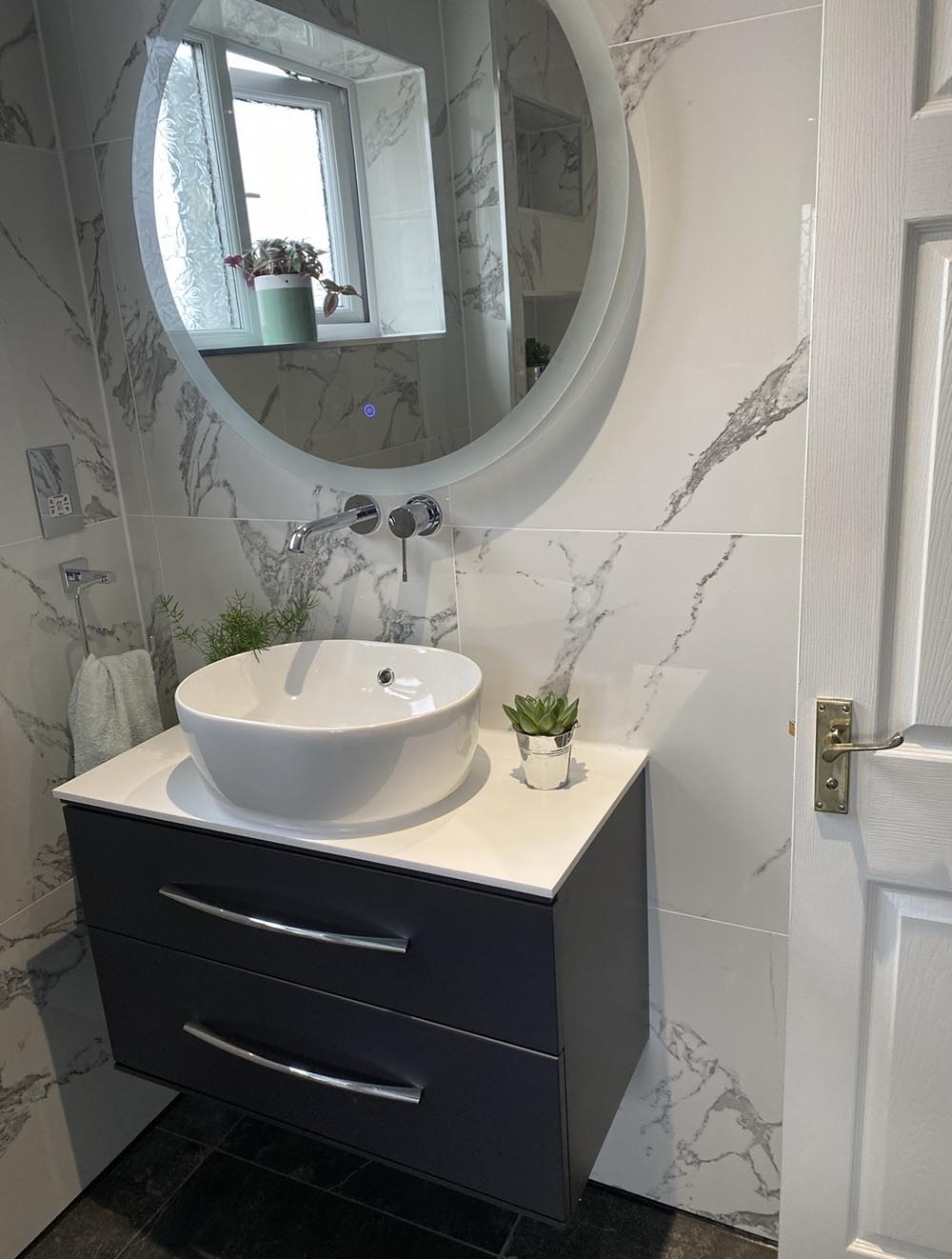 Large white marble tiles in a bathroom